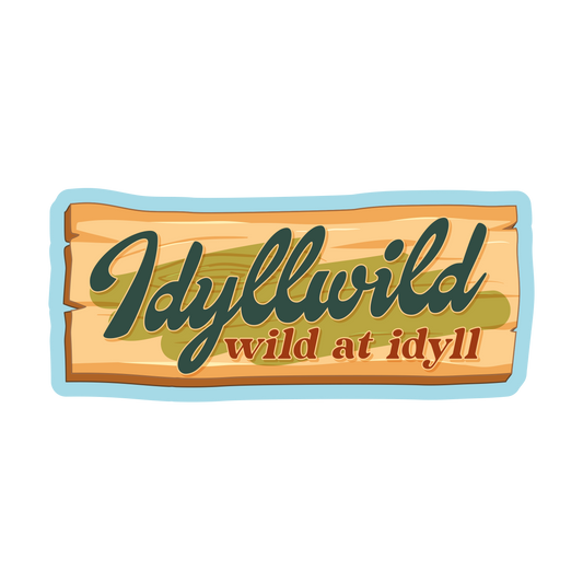 Wooden sign with 'Idyllwild wild at idyll' text on a white background