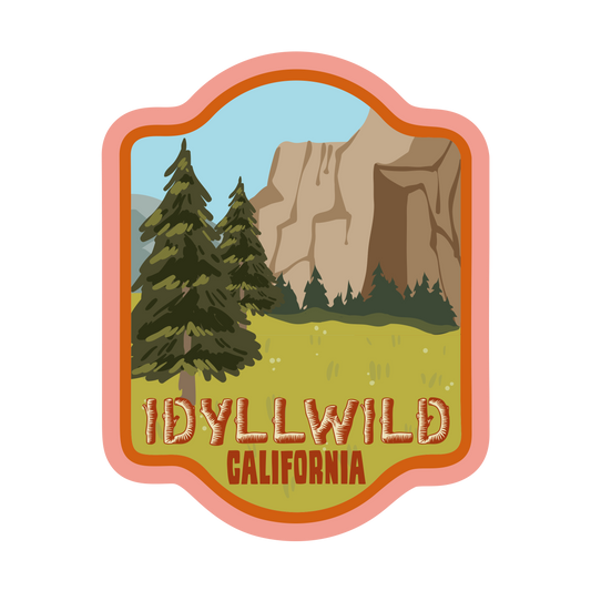Stylized badge with trees, mountains, and 'Idyllwild California' text on a white background