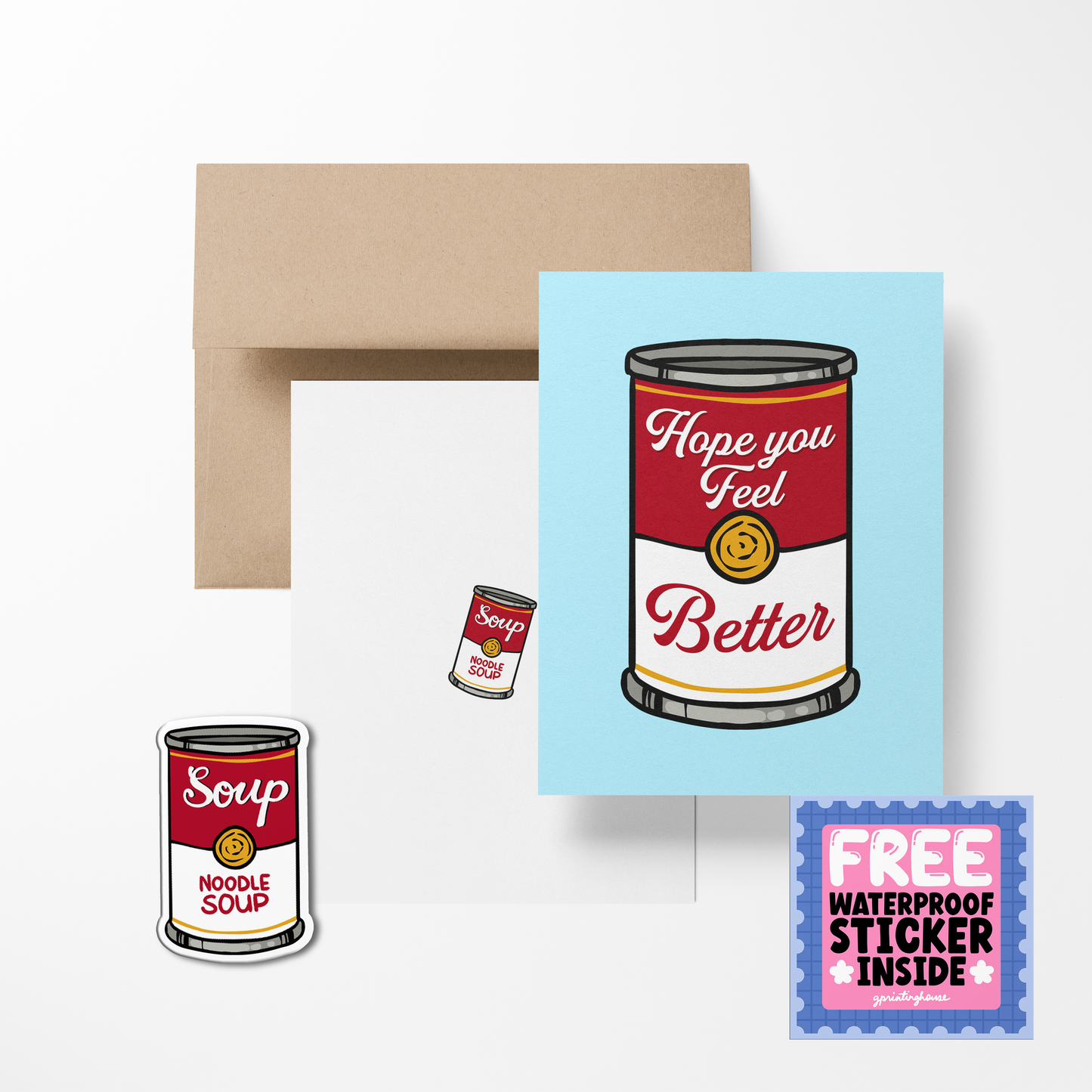 A greeting card with an illustration of a soup can, with the text 'Hope you feel better', accompanied by a brown envelope and a free waterproof vinyl sticker.