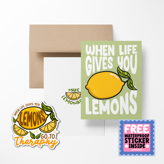 A greeting card with a lemon illustration and a text play on the phrase 'when life gives you lemons', accompanied by a free waterproof vinyl sticker, displayed with an envelope.