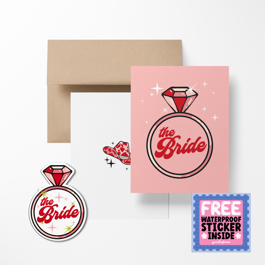 A greeting card with a pink background featuring the text 'the Bride' in a decorative font, surrounded by sparkle illustrations, with an envelope and a waterproof sticker included.