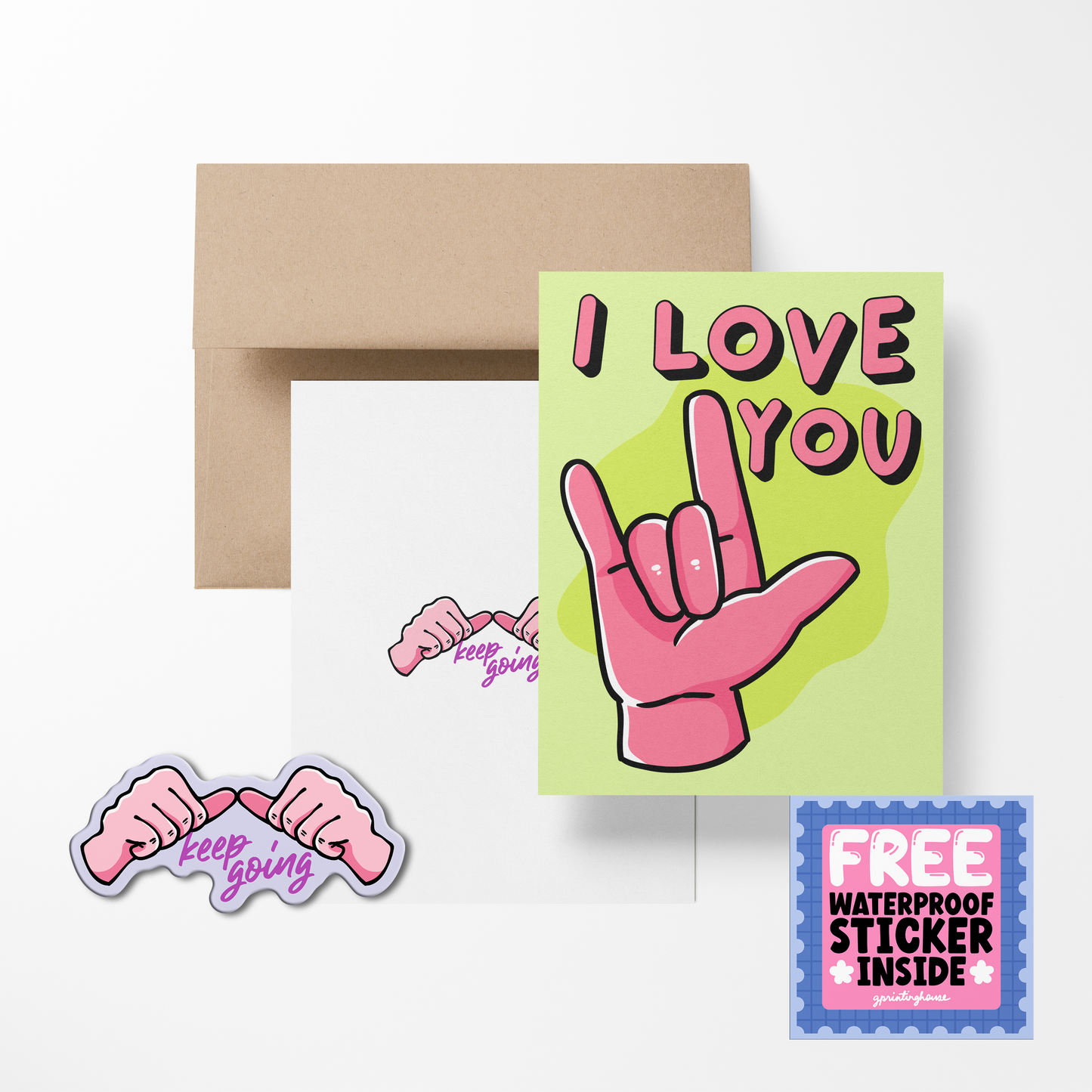 A greeting card with 'I LOVE YOU' text and a heart symbol, accompanied by a sticker with the text 'Keep Going'. There is also a brown envelope in the background.