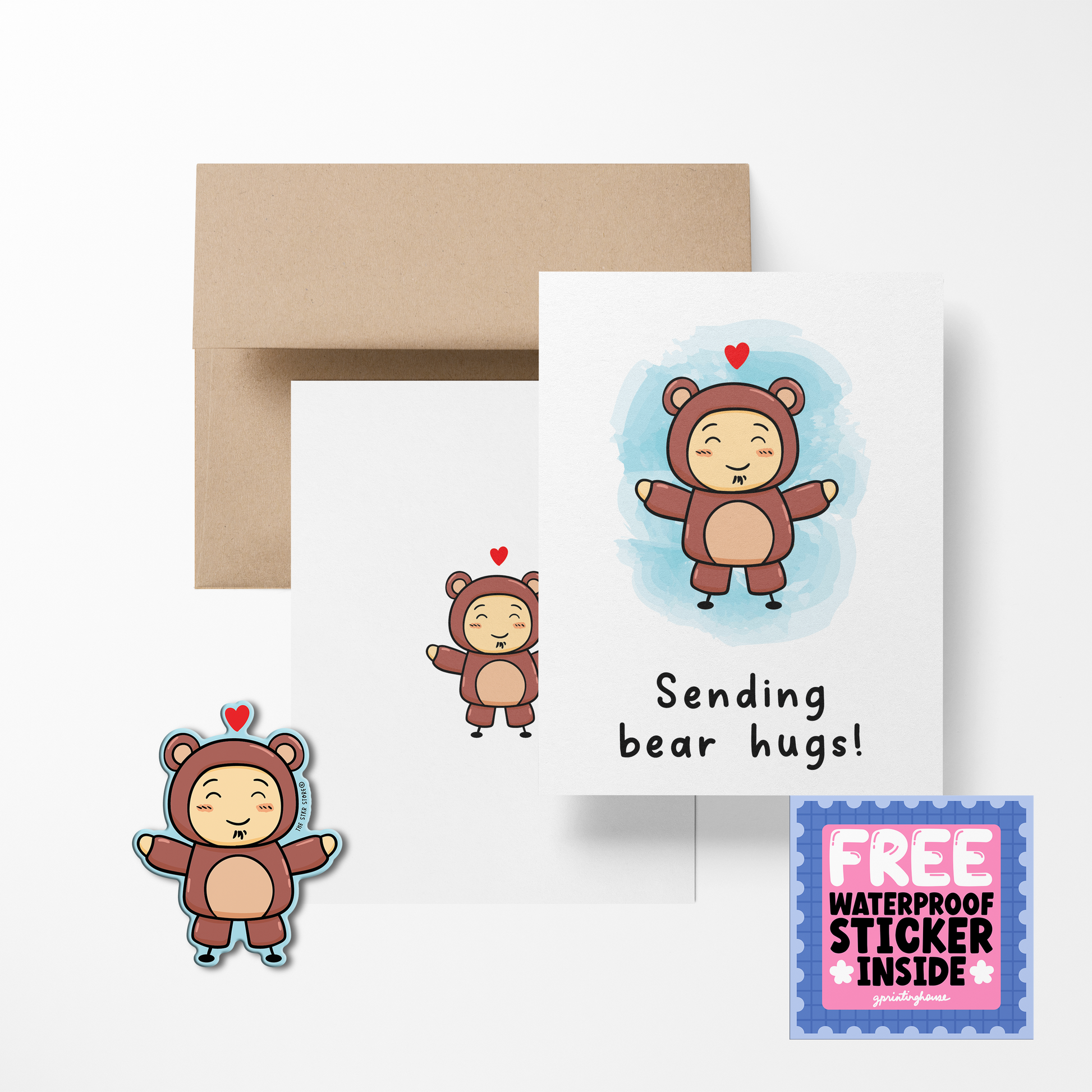 A greeting card with a cute bear illustration, titled 'Sending bear hugs!' accompanied by a brown kraft paper envelope and a free waterproof vinyl sticker.