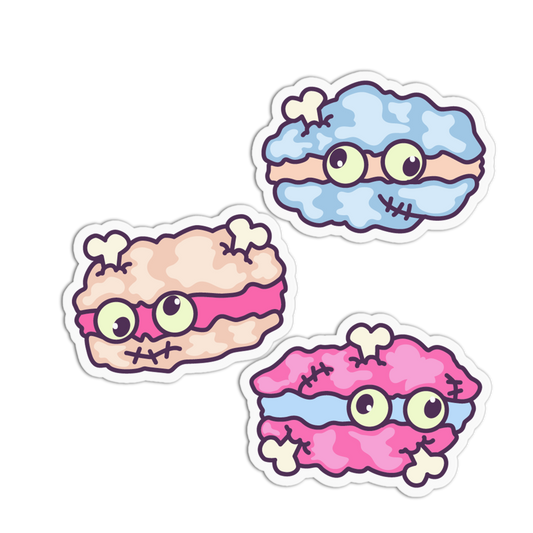 Three cartoon macaroni-shaped stickers with googly eyes and stitched faces on a white background.