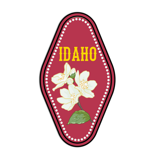 Decorative emblem with 'Idaho' text and floral design on a red background