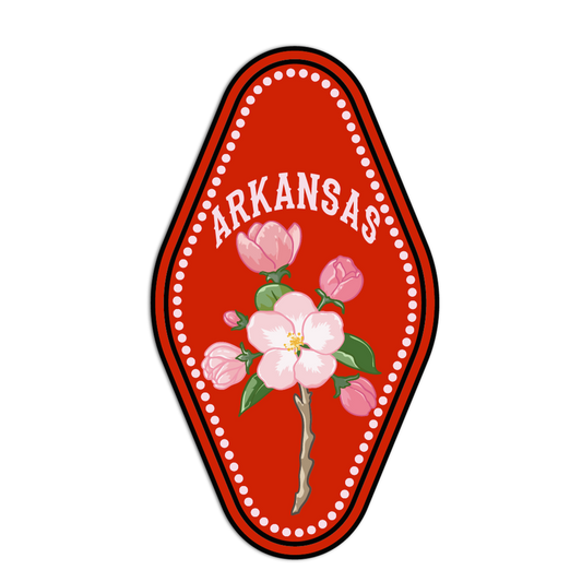 Decorative emblem with pink flowers and 'ARKANSAS ' text on a red background