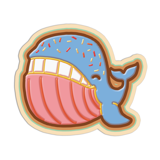 Colorful cookie cutter shaped like a whale with a smiling expression on a white background