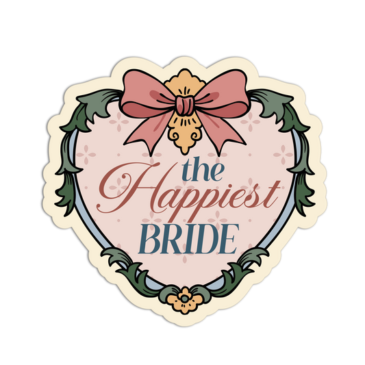 A die-cut heart-shaped sticker with the text 'the Happiest BRIDE' in decorative lettering, framed by a floral border and topped with a pink bow, shown on a plain white background.