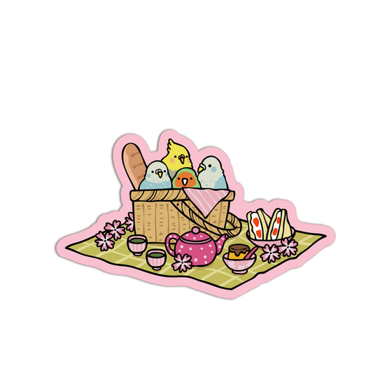 Illustration of a picnic basket with birds, teapot, and food on a blanket
