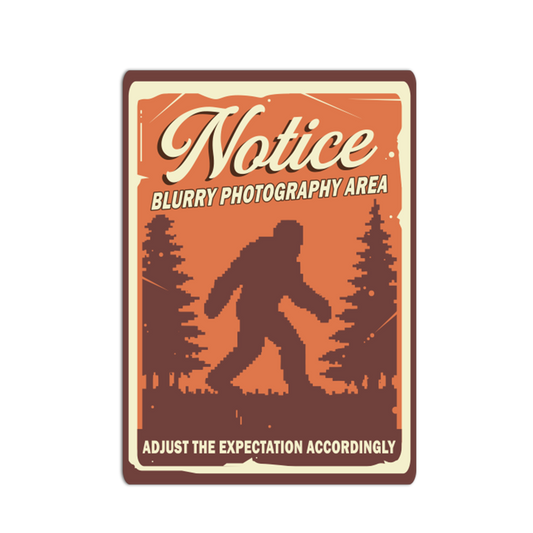 Vintage-style sign with a silhouette of a bigfoot and text about blurry photography area.