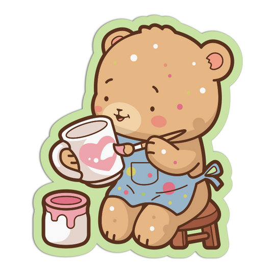 Cartoon bear painting a heart on a mug with a jar of paint and brush.