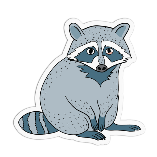 A die-cut vinyl sticker featuring a cartoon illustration of a raccoon in shades of gray, blue, and white, shown on a plain white background.