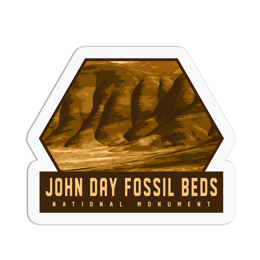 Sticker of John Day Fossil Beds National Monument with a brown hexagonal design on a white background.